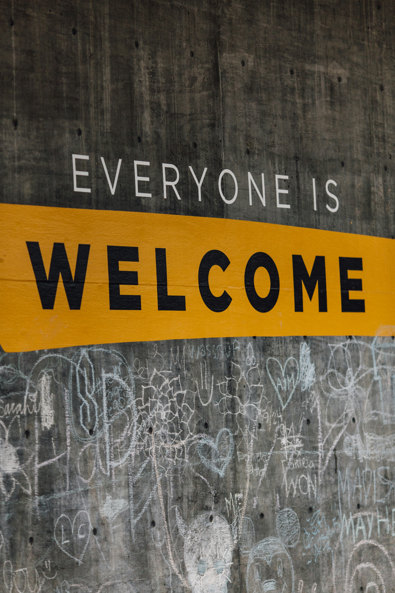 Public wall sign reading everyone is welcome